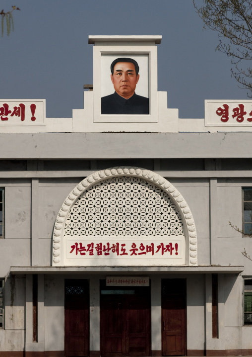 Kim il Sung portrait at the top of an official building, South Pyongan Province, Nampo, North Korea
