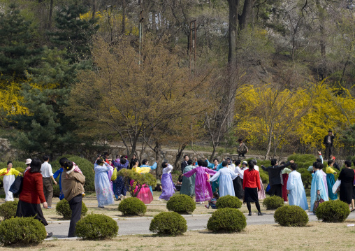 North Korean people dancing in a park for the day of the sun which is the birth anniversary of Kim Il-sung, Pyongan Province, Pyongyang, North Korea