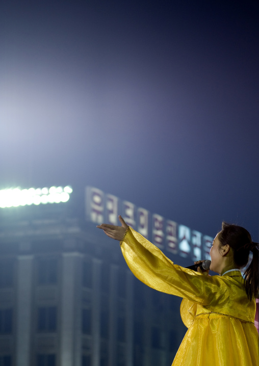 North Korean singer during a mass dance to celebrate april 15 the birth anniversary of Kim Il-sung on Kim il Sung square, Pyongan Province, Pyongyang, North Korea