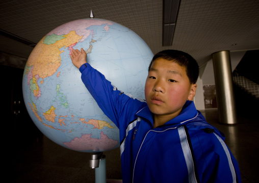 North Korean boy showing North Korea on a world map in Songdowon international children's camp, Kangwon Province, Wonsan, North Korea