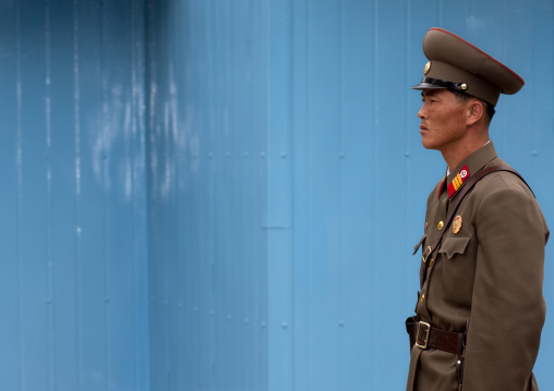 North Korean soldier standing in front of the United Nations conference rooms on the demarcation line in the Demilitarized Zone, North Hwanghae Province, Panmunjom, North Korea