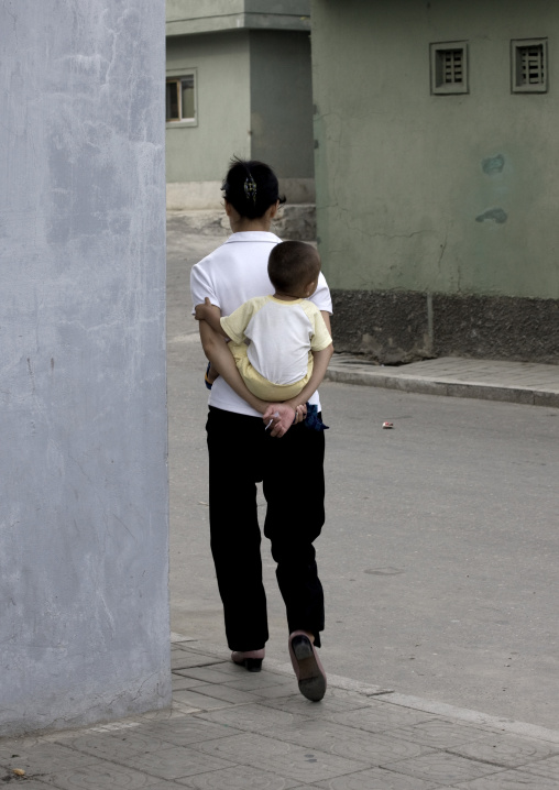 North Korean woman carrying her baby in her back, Pyongan Province, Pyongyang, North Korea
