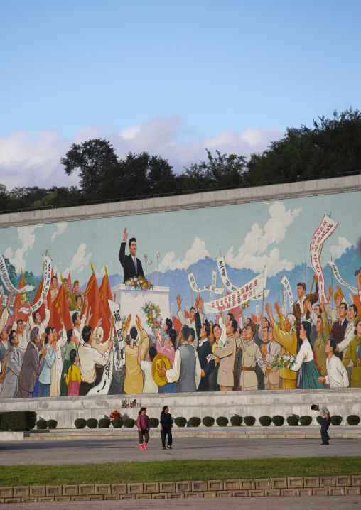 North Korean people passing in front of a giant Kim il Sung mosaic fresco, Pyongan Province, Pyongyang, North Korea