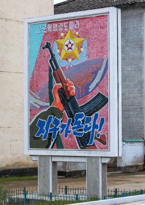 Propaganda billboard and a slogan saying planet turns according to songun revolutionary leadership, South Hamgyong Province, Hamhung, North Korea