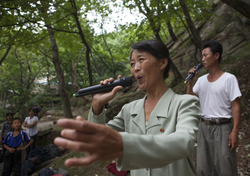 North Korean electricity company worker singing in a park, North Hwanghae Province, Kaesong, North Korea