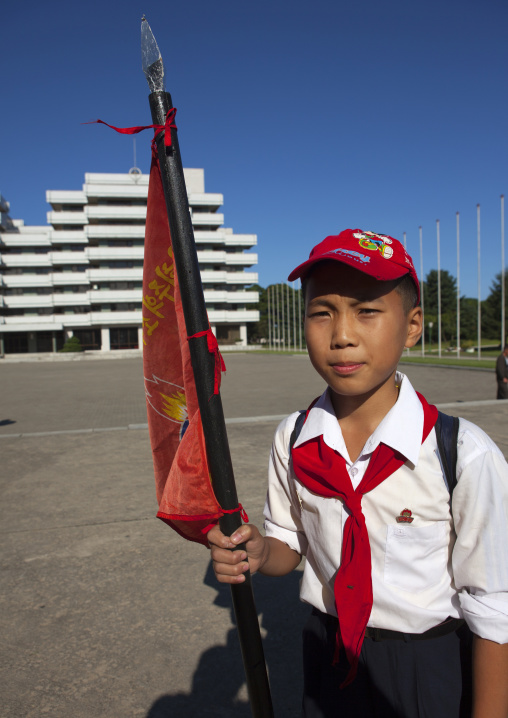 North Korean pioneer holding a flag in Songdowon international children's camp, Kangwon Province, Wonsan, North Korea
