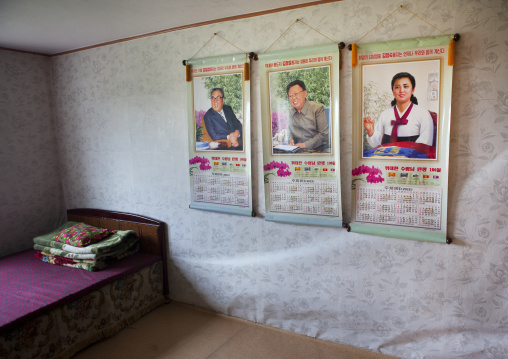 Bedroom in a North Korean house with the Dear Leaders portraits on the wall, South Hamgyong Province, Hamhung, North Korea