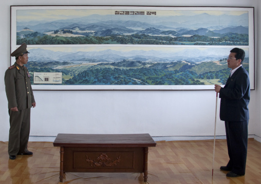 North Korean colonel and a guide in front of the map of the Demilitarized Zone wall area, North Hwanghae Province, Panmunjom, North Korea