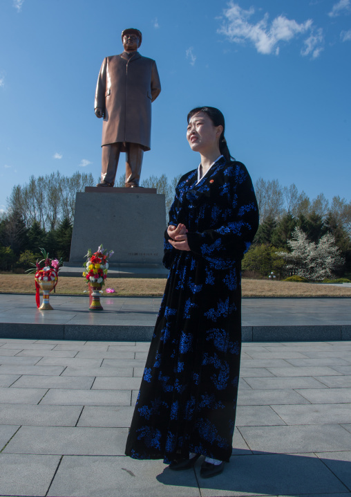 North Korean woman in front of Dear leader Kim il Sung statue on main square, North Hamgyong Province, Chongjin, North Korea