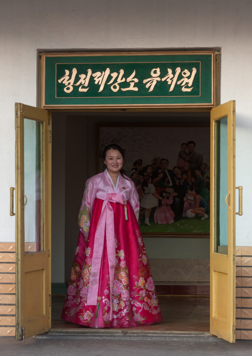 Portrait of a North Korean woman in traditional choson-ot in the entrance of a school, North Hamgyong Province, Chongjin, North Korea