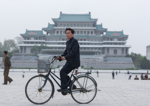 North Korean man riding a bicycle on Kim il Sung square, Pyongan Province, Pyongyang, North Korea