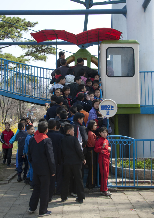 North Korean children queueing for the big wheel in Taesongsan funfair, Pyongan Province, Pyongyang, North Korea