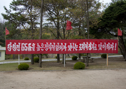 Propaganda billboard in the street for the 65th anniversary of the birth anniversary of Kim Il-sung, North Hwanghae Province, Kaesong, North Korea