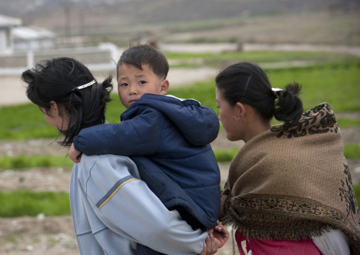 North Korean woman carrying her children on her back, Kangwon Province, Wonsan, North Korea
