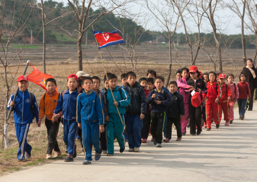 North Korean children parading in the streets on the international workers' day with the national flag, Kangwon Province, Wonsan, North Korea