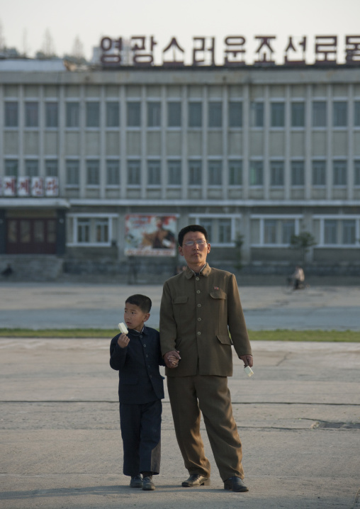 North Korean father and son eating an ice cream in the main square, Kangwon Province, Wonsan, North Korea