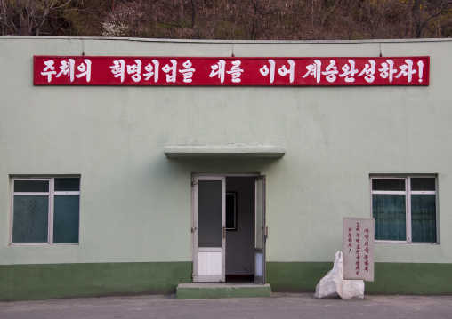 Propaganda slogan above the entrance of a building saying let us accomplish the succession by continuing the great revolutionary success of juche!, Ryanggang Province, Samjiyon, North Korea