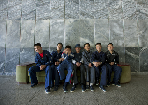 Group of North Korean boys sitting and laughing on a bench at the Songdowon international children's camp, Kangwon Province, Wonsan, North Korea