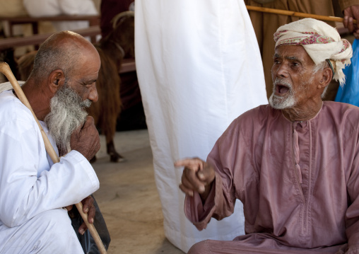 Two Old Men Bargaining In Sinaw Market, Oman