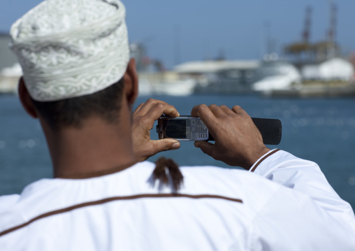 Oman Man Using Phone To Take Pictures, Muscat, Oman