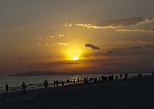 Geoup Of Men Walking Alone The Beach Under The Sunset, Salalah, Oman