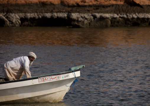 Fisherman Bending Down On The Boat, Sur, Oman
