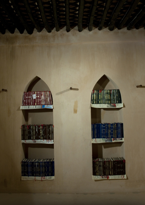 Arabic Book Shelf Full Of Books On The Wall In Sineslah Fort, Sur, Oman