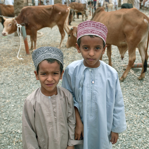Two Kids In Traditional Costumes At Nizwa Market, Oman