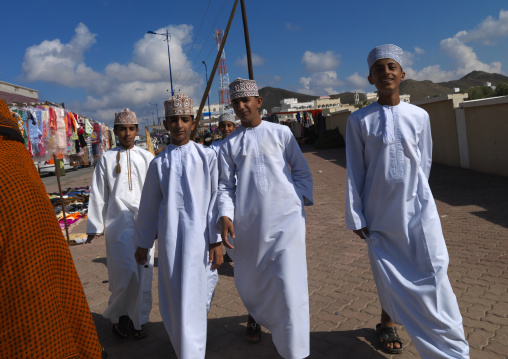 Boys Wearing Traditional Cloths And Walking Together In Ibra Market, Oman