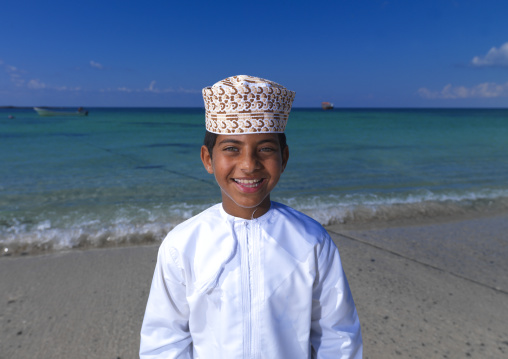 Smilling Boy Wearing Dishdasha And Standing On The Beach, Masirah Island, Oman