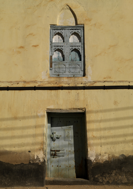 Wall Of Old Dhofari House With Wooden Carved Windows And Doors, Taqa, Oman