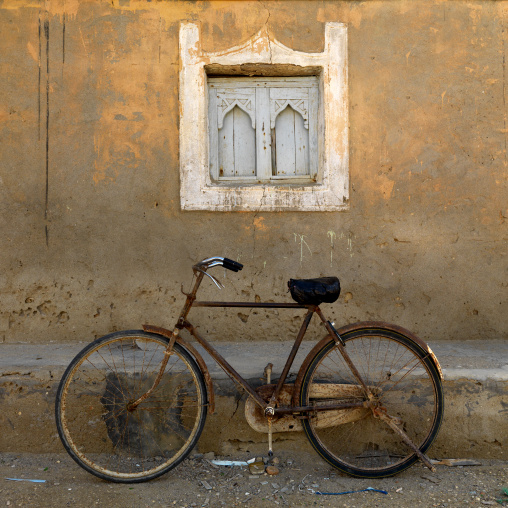 Rusted Bike Under A White Carved Window, Mirbat, Oman