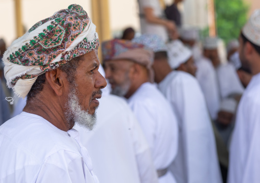 Omani men in the cattle market, Ad Dakhiliyah Region, Nizwa, Oman