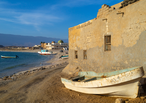 Fisherman boat in front of an old house, Dhofar Governorate, Mirbat, Oman