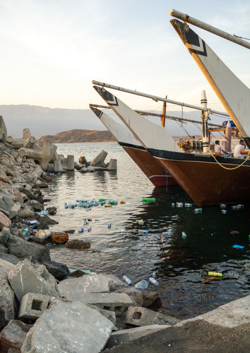 Pollution in the sea in front of dhows in the port, Dhofar Governorate, Mirbat, Oman