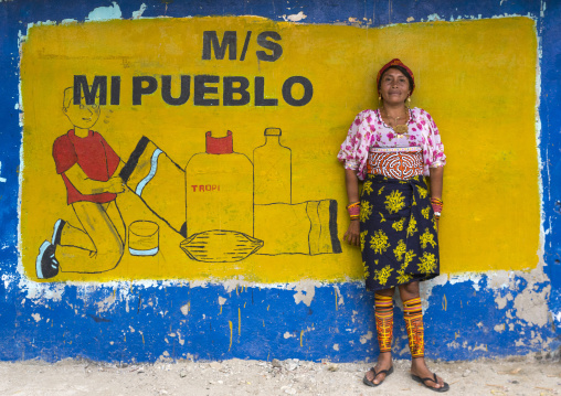 Panama, San Blas Islands, Mamitupu, Kuna Tribe Woman In Front Of An Advertising