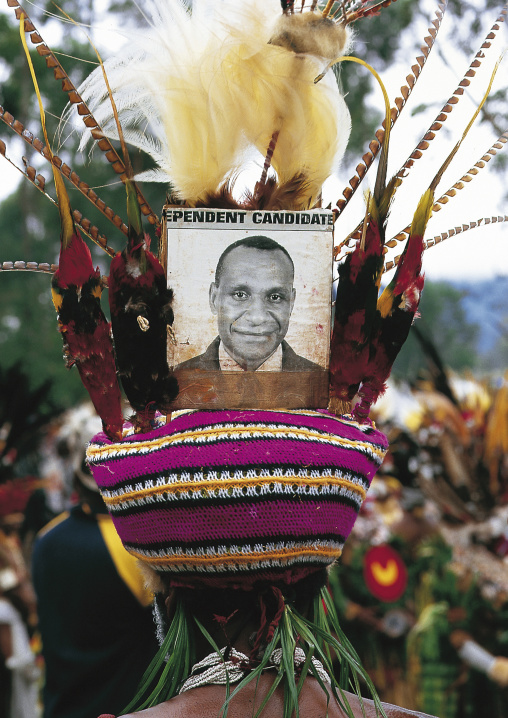 Highlander warrior with a picture of a politician on his headdress during a sing-sing, Western Highlands Province, Mount Hagen, Papua New Guinea