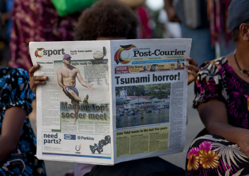 Woman reading news about a tsunami, East New Britain Province, Rabaul, Papua New Guinea