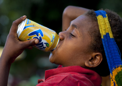 Boy drinking fanta can, East New Britain Province, Rabaul, Papua New Guinea