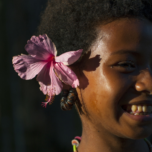 Little girl wearing earrings made with turtle shell, Milne Bay Province, Trobriand Island, Papua New Guinea