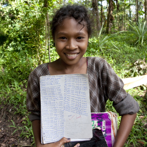 Islander girl with school works, Milne Bay Province, Trobriand Island, Papua New Guinea