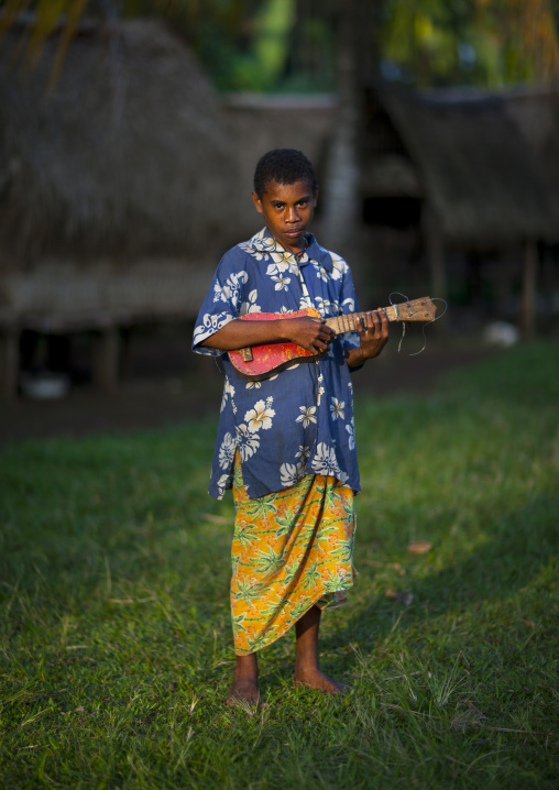 Islander girl playing guitar, Milne Bay Province, Trobriand Island, Papua New Guinea