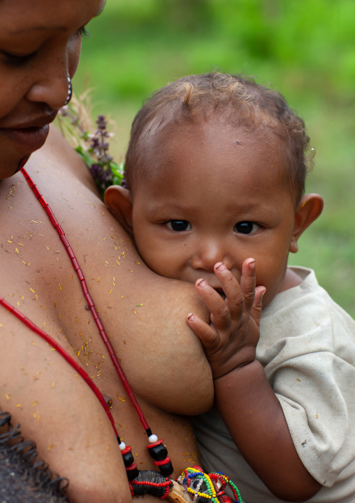Mother breastfeeding her child, Milne Bay Province, Trobriand Island, Papua New Guinea