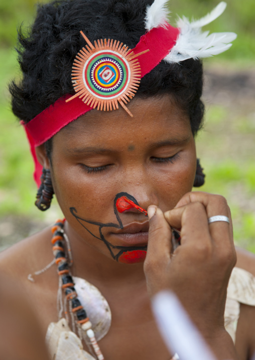 Tribal woman makeup before a ceremony, Milne Bay Province, Trobriand Island, Papua New Guinea