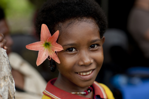 Smiling girl with flowers in the hair, Milne Bay Province, Trobriand Island, Papua New Guinea