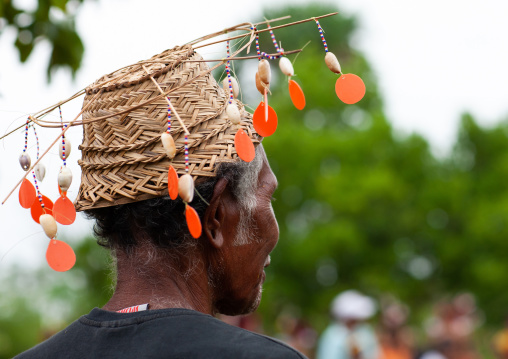 Man wearing a decorated hat during a ceremony, Milne Bay Province, Trobriand Island, Papua New Guinea