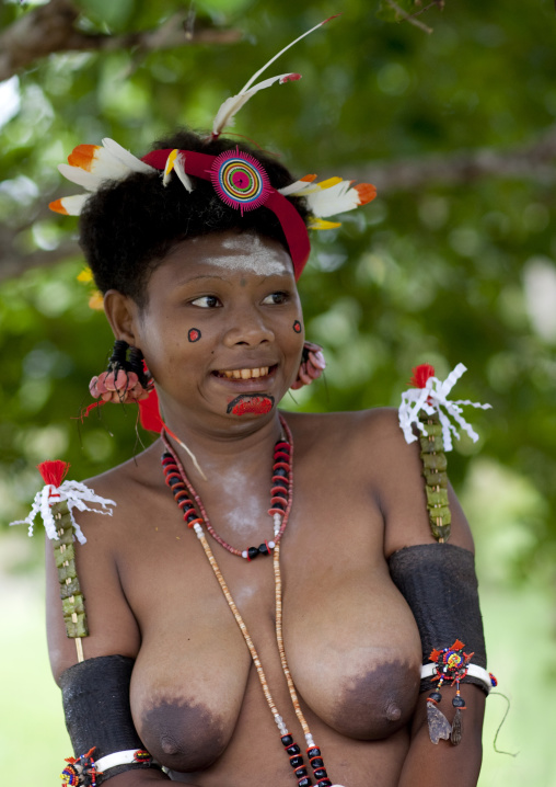 Portrait of a smiling topless tribal woman in traditional clothing, Milne Bay Province, Trobriand Island, Papua New Guinea