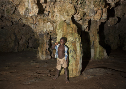 Boy inside momuni sacred cave, Autonomous Region of Bougainville, Bougainville, Papua New Guinea