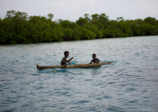 Children on a canoe on water, Autonomous Region of Bougainville, Bougainville, Papua New Guinea