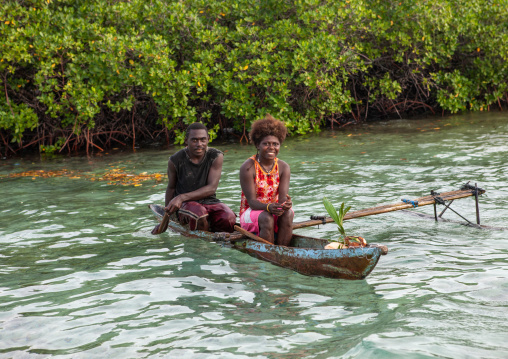 Couple on a canoe on water, Autonomous Region of Bougainville, Bougainville, Papua New Guinea